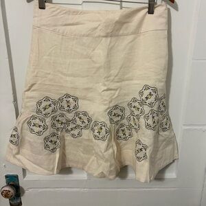 Anthropologie Odille brand linen-blend A-line skirt featuring floral embroidery.